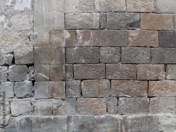 Fototapeta Old stone wall with textured masonry blocks. Can be used as elements or background for design projects. 