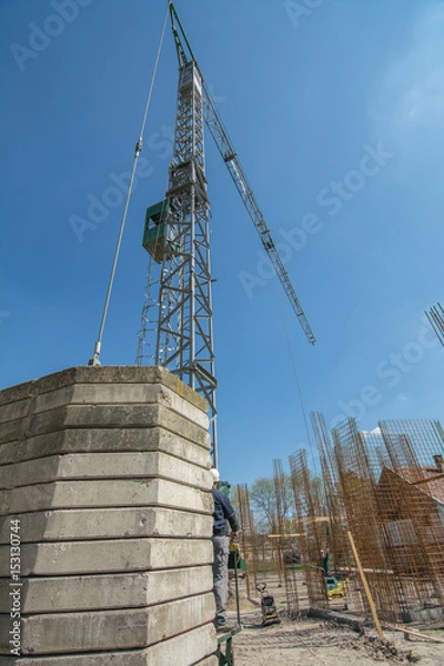 Obraz Building crane and worker operator at construction 