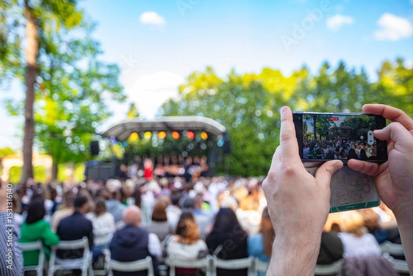 Obraz Person Filming an Outdoor Concert  with a Smartphone