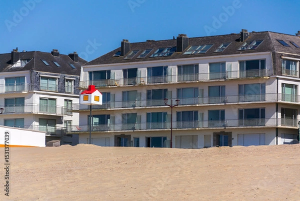 Obraz Wooden model of a house with a red roof on a pole on a sandy beach, coastal village De Haan, West Flanders, Belgium
