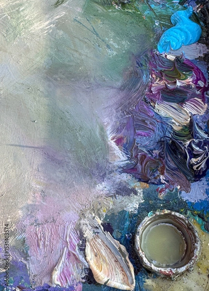 Fototapeta Close-up of an artist’s palette filled with mixed oil paints. Blue tone. Textured colors background. Horiszontal