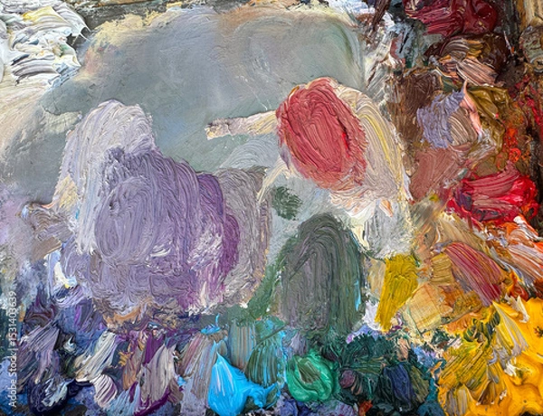 Fototapeta Close-up of an artist’s palette filled with mixed oil paints. Textured colors background. Horiszontal