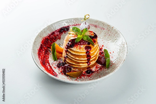 Fototapeta Pancakes with jam and mint on a white table