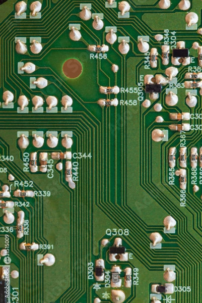 Obraz Detailed close-up of an electronic circuit board, vertical photo