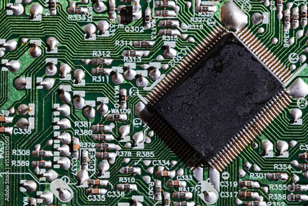 Obraz A  microchip soldered on an intricate green electronic circuit board