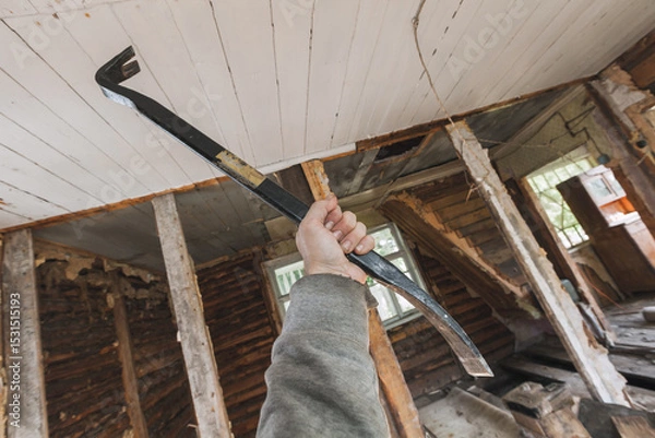 Obraz Expressive image of a construction worker using a crowbar
