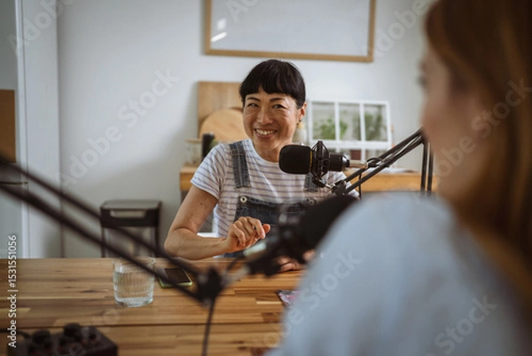 Obraz under the shoulder view of japanese host record podcast at home studio