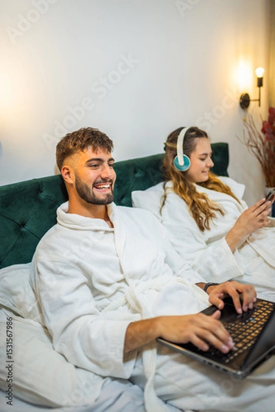 Fototapeta Modern Couple in Bed – Separate Digital Worlds, Shared Space