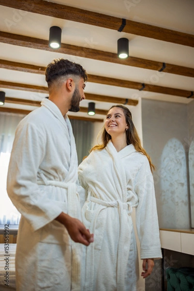 Fototapeta Couple in Bathrobes Looking at Each Other in Hotel Room