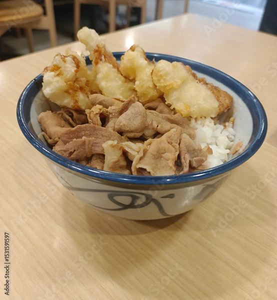 Fototapeta top view Pork stir-fried in Korean sauce, served over rice in a bowl on a wooden table, food, hot, delicious, valuable, copy space