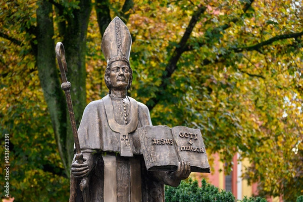 Obraz Saint Paulinus of Trier – a bronze statue near the Basilica of St Paulinus in Trier, Germany. "Jesus = Gott + Mensch" [Jesus = God + Man].