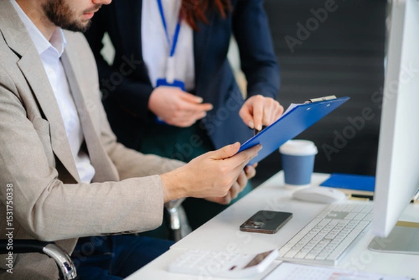 Fototapeta Businessman and team analyzing financial statement Finance task. with smart phone and laptop