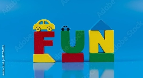 Fototapeta Colorful wooden blocks spelling out FUN with toy cars and house