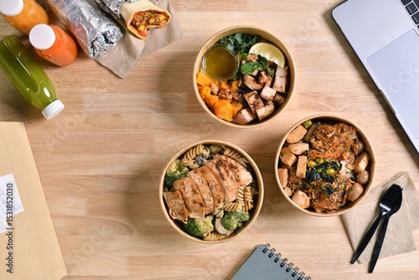 Fototapeta Having a lunch break at the office with delicious Healthy food delivery in take away boxes, Healthy eating concept.