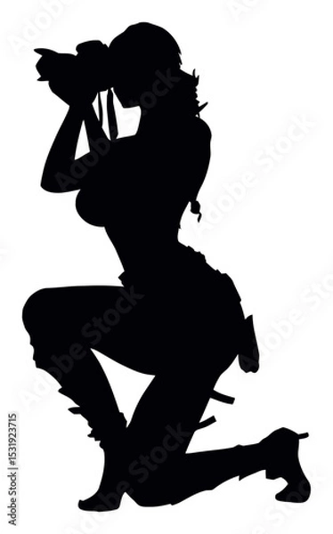 Fototapeta Silhouette of a Woman Photographer Kneeling with Camera for Stock Use