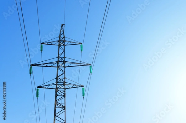 Fototapeta Power line support with high-voltage wires with exposure to the sun.