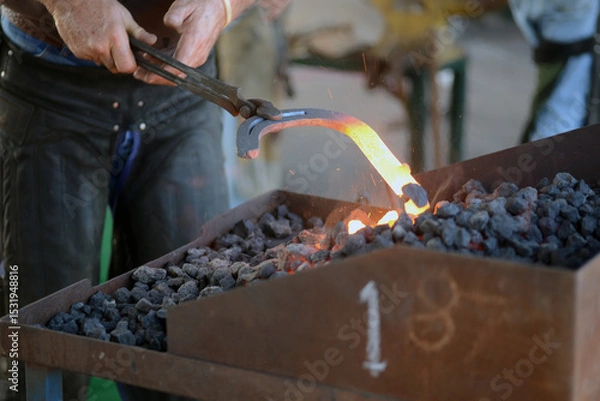 Fototapeta farrier heats the horseshoe