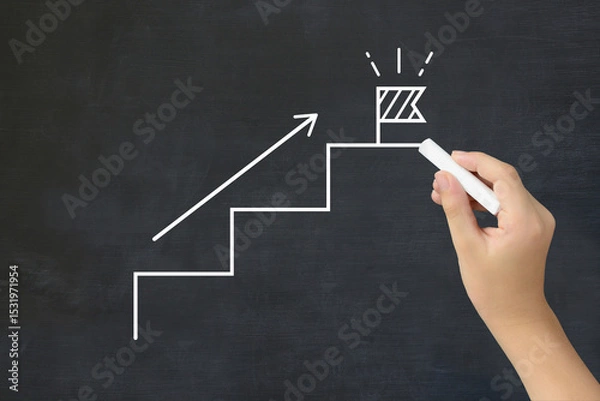Obraz 旗の建てられたステップを黒板に描く子どもの手