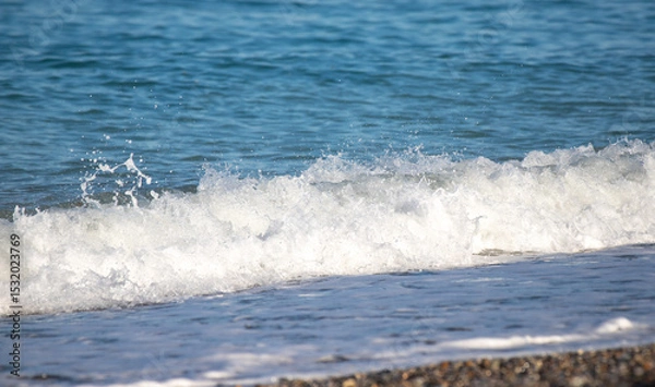 Fototapeta The ocean waves are crashing onto the shore, creating a beautiful
