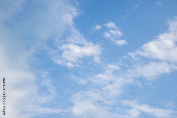 Fototapeta The sky is blue and clear with a few clouds scattered throughout