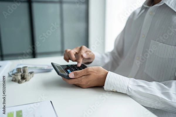 Fototapeta Businessman checking bills taxes bank account balance and calculating annual financial statements of company. Accounting Audit Concept