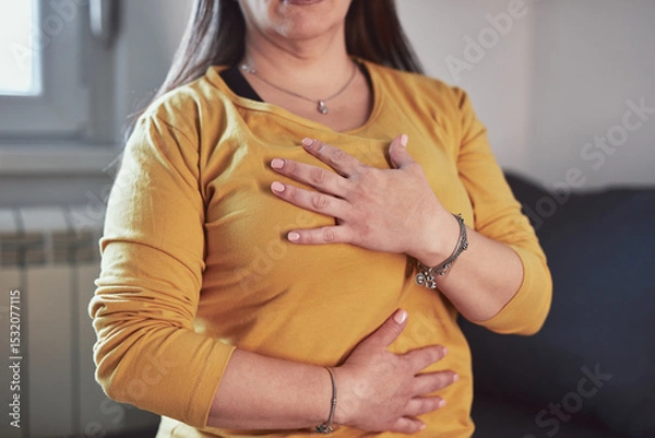 Fototapeta Woman with strong stomach ache, menstrual and digestive issues at home.