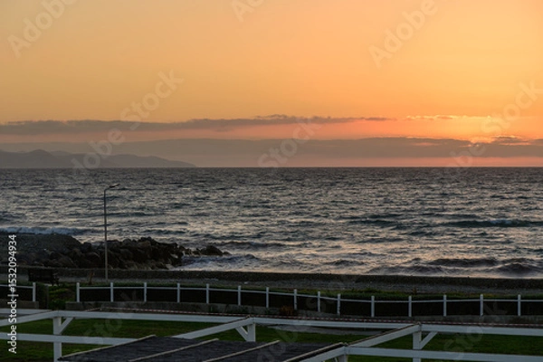 Obraz Colorful and dramatic sunset sky over the island of Cyprus, with glowing clouds and warm Mediterranean light.