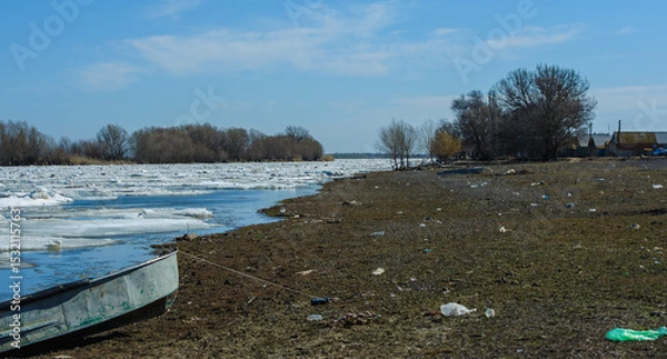 Obraz Large chunks of ice float down the Bakhthiyar River during spring thaw