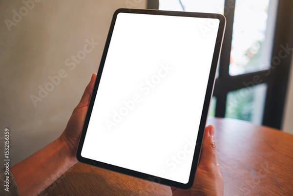 Fototapeta Mockup image of a woman holding digital tablet with blank white desktop screen