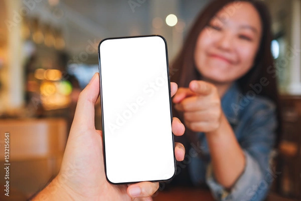 Fototapeta Mockup image of a man holding and a woman pointing finger at mobile phone with blank screen
