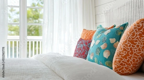 Obraz Close-up of a bed with four colorful throw pillows on it. the pillows are arranged in a row on the right side of the bed, with the largest one in the center and two smaller ones on the left side.