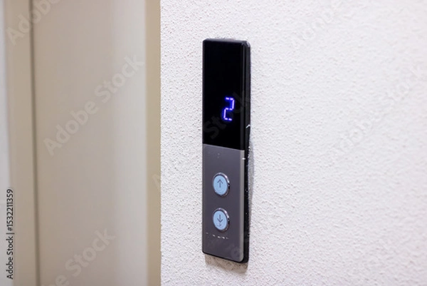Fototapeta A sleek black elevator button featuring the number 2 prominently on it