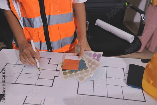 Fototapeta Closeup of team of industrial engineers meeting analyze machinery blueprints consult project on table in manufacturing factory. Working in manufacturing plant or production plant.