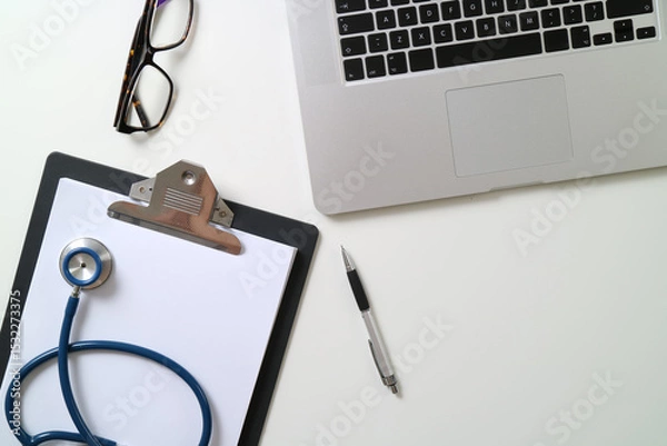 Fototapeta Doctor's Desk with Laptop, Clipboard, and Stethoscope