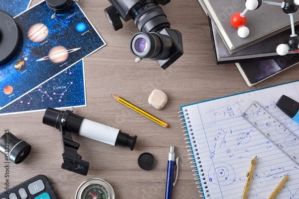 Fototapeta Astronomy student workspace with bench with items for astronomical study