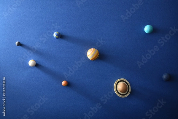 Fototapeta Solar system concept with planets on textured blue cardboard