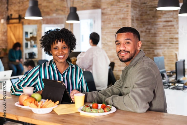 Fototapeta Business people enjoying break time with healthy food and digital tablet