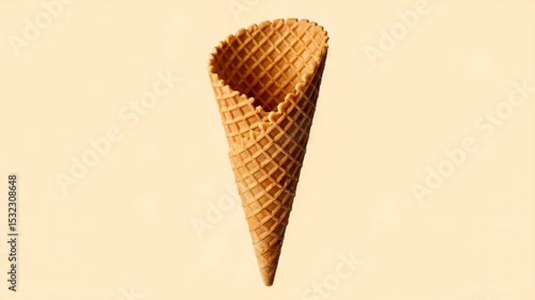 Obraz A waffle cone, typically used for serving ice cream. It's elongated and slightly curved, with a textured, crisscross pattern on its surface.