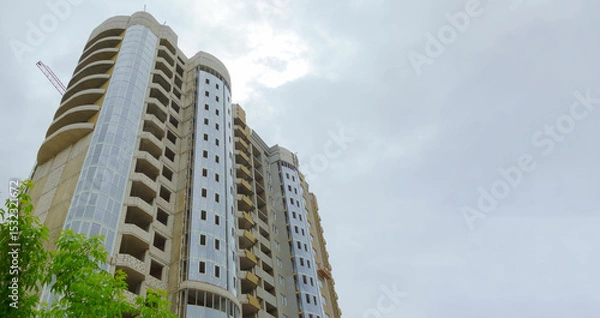 Obraz Construction of new high-rise buildings against a bright sky