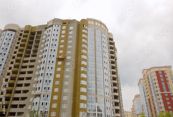 Obraz Construction of new high-rise buildings against a bright sky