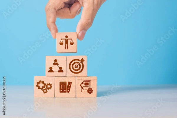 Obraz Wooden cube with ethics symbol held in hand. Represents corporate responsibility, integrity, and compliance in business practices.