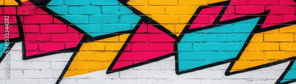 Fototapeta Vibrant graffiti art brick wall with abstract colorful shapes red, blue, yellow, and white creating dynamic urban expression