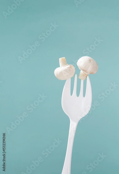 Fototapeta champignon on big white fork on green background