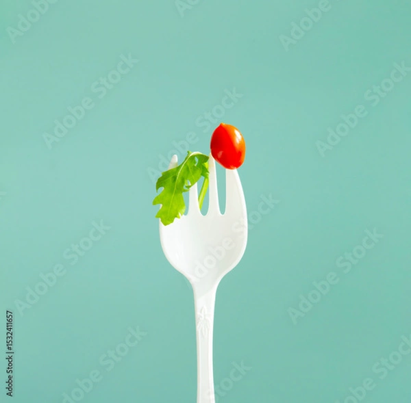 Fototapeta little red  tomato on big white fork
