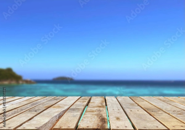 Obraz Wooden table top on the beach or sea.Party on the beach  sunshine time concept.For montage product display or design key visual layout.View of copy space.