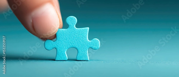 Fototapeta Assembling a jigsaw puzzle piece a closeup of a blue hand connecting an unfinished task in a business environment symbolizing imagination and collaboration
