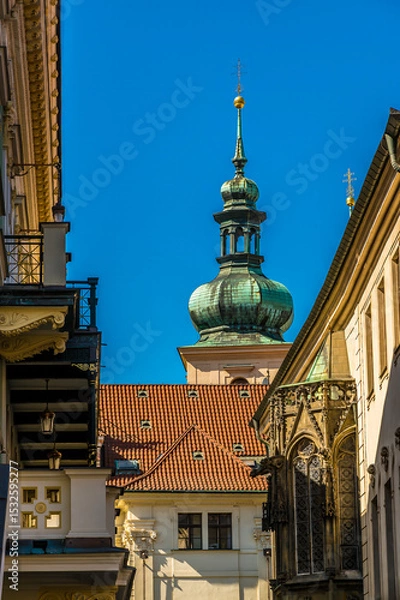 Fototapeta A view down a side street beside the Powder Tower  in central Prague in springtime