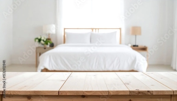 Obraz A soft, bright bedroom scene featuring a clean wood table for product placement or mockup display.