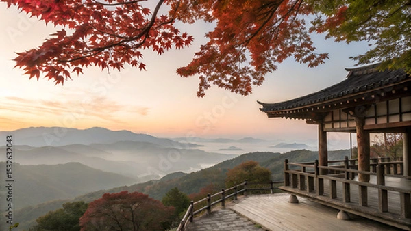 Obraz Traditional wooden terrace on the right side, overlooking a misty mountain valley at sunrise. Red maple leaves frame the top right corner, creating a serene and poetic autumn scene with soft pastel sk
