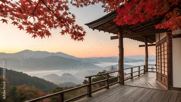 Obraz Traditional wooden terrace on the right side, overlooking a misty mountain valley at sunrise. Red maple leaves frame the top right corner, creating a serene and poetic autumn scene with soft pastel sk